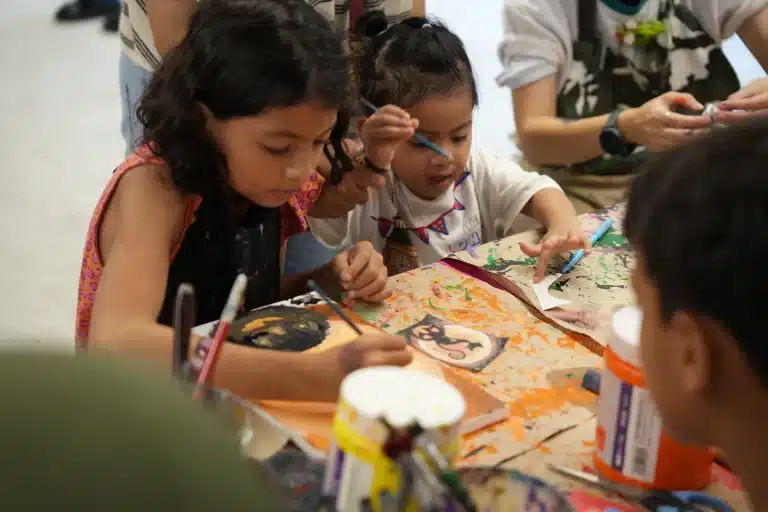 Children painting at an art activity table